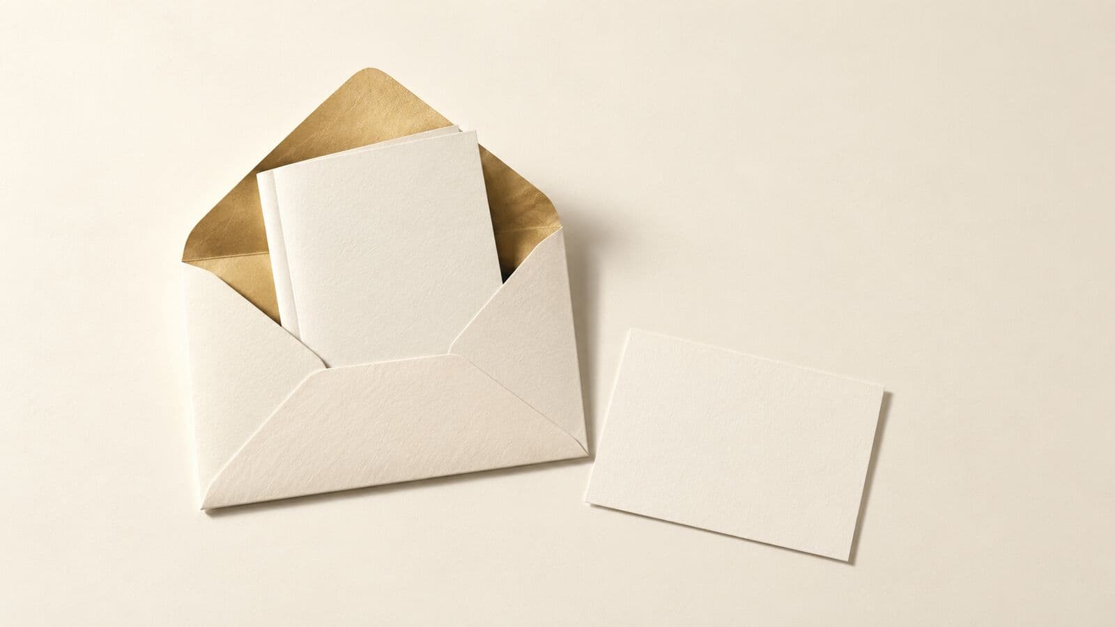 Paper cut-out of a small folded guide inside an open envelope beside a single blank signup card.